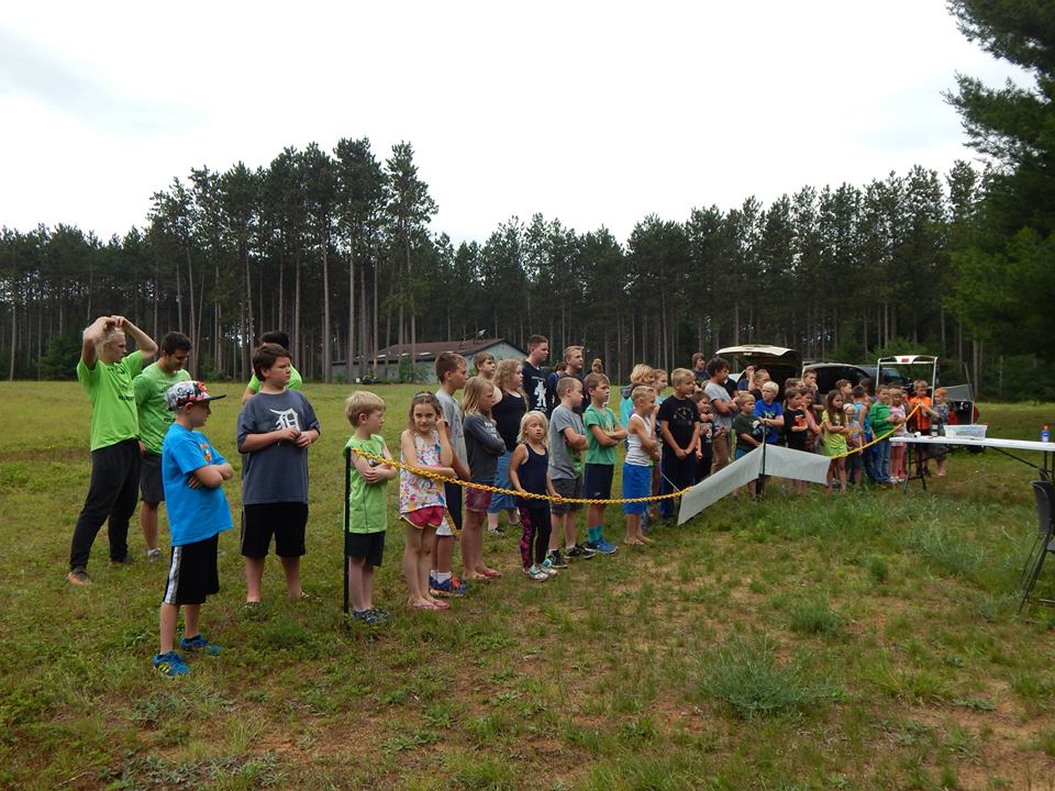 group of youth line up to learn about safety at the range