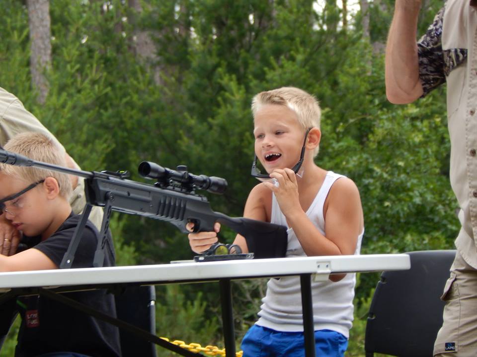 boy looks excited after shooting at the range