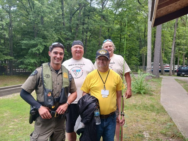 CSYDV volunteers and veterans with a DNR conservation officer at a fishing outing in Croton River Country
