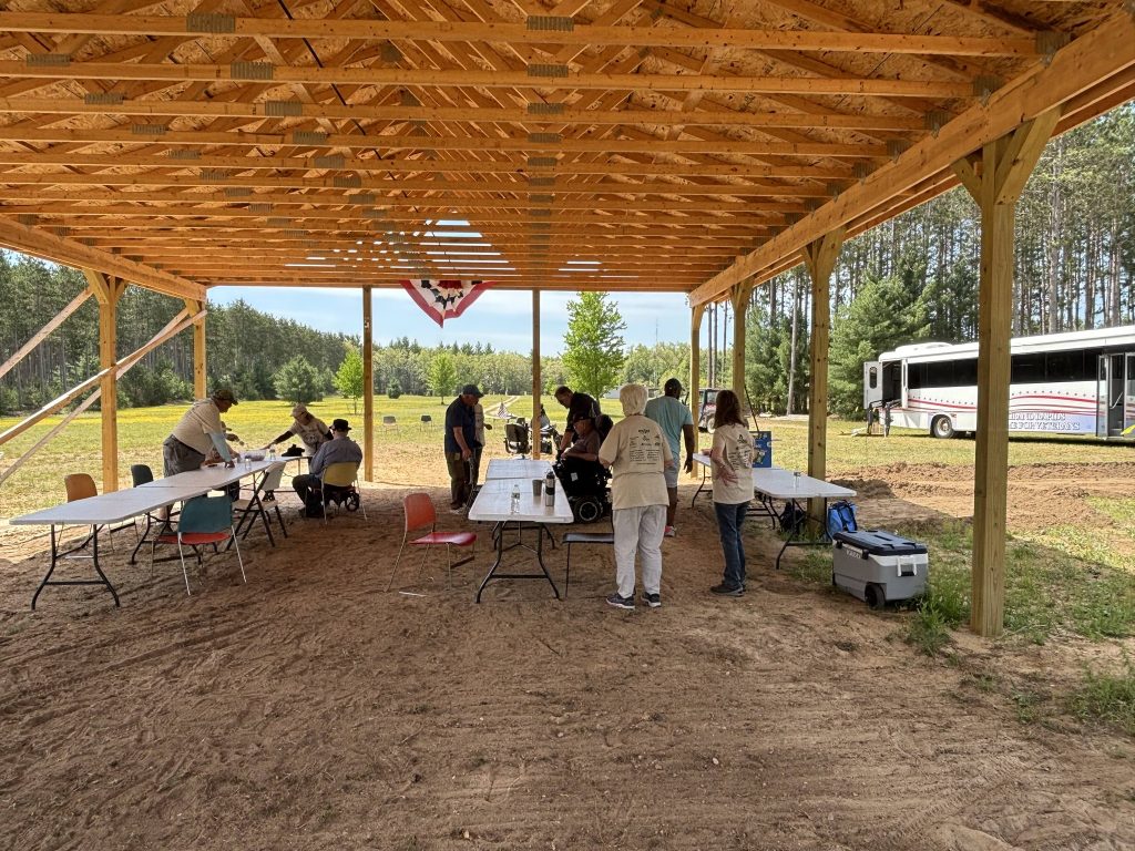 Volunteers set up as veterans arrive at the new pavilion