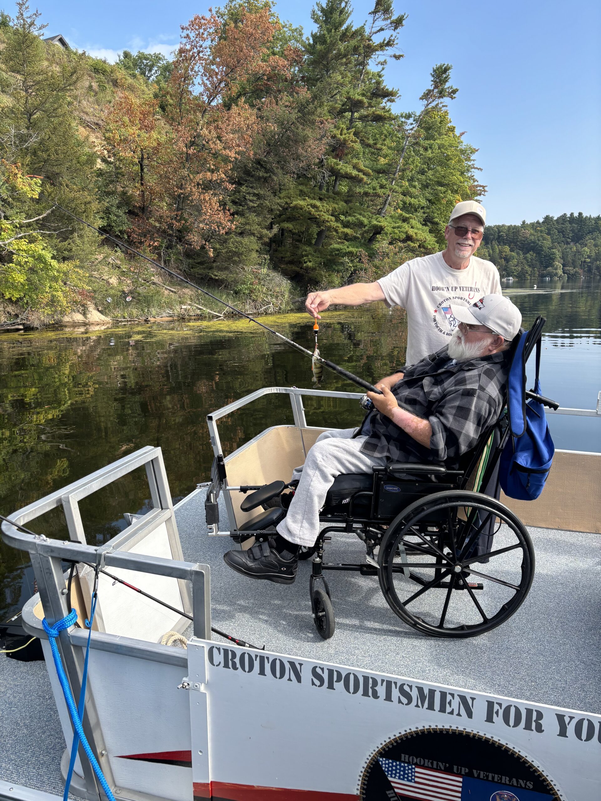 A veteran and volunteer show off their latest catch on the CSDVY boat