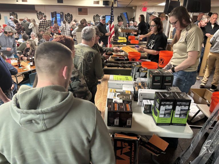 display of items at Whitetails Unlimited event and event participants